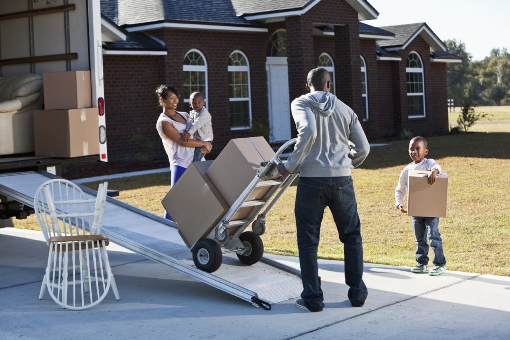 family loading a vehicle for moving